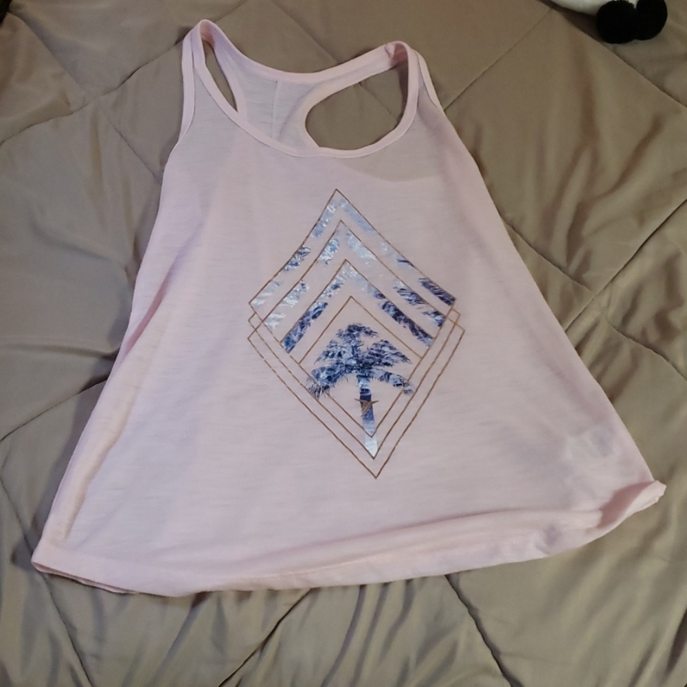 A light pink tank top with a design